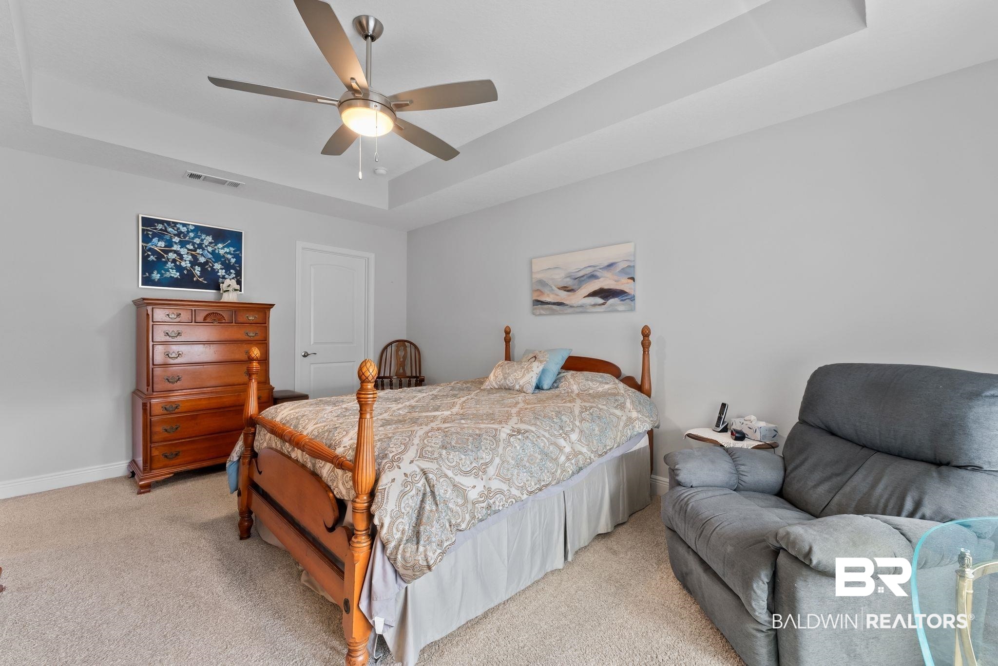 32868 Arbor Ridge Circle Lillian, AL 36549 - Photo 18 of 35 Bedroom featuring a raised ceiling, light carpet, and a ceiling fan