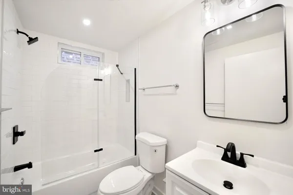 a bathroom with a tub and shower