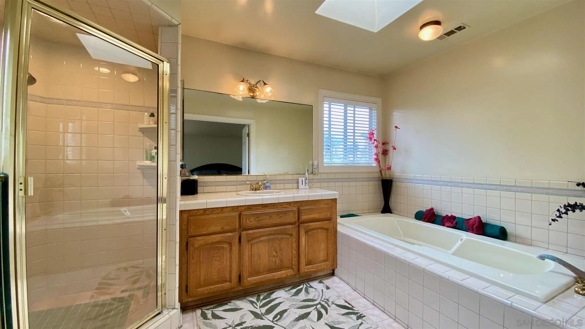 167 Marcheta Street Encinitas, CA 92024 - Photo 17 of 21 a bathroom with a tub sink mirror and a shower