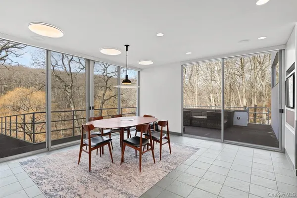 a view of a dining room with furniture window and outside view