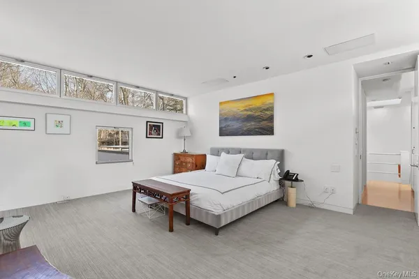 a spacious bedroom with a bed and a cabinets