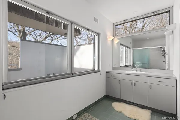 a bathroom with a double vanity sink and a mirror