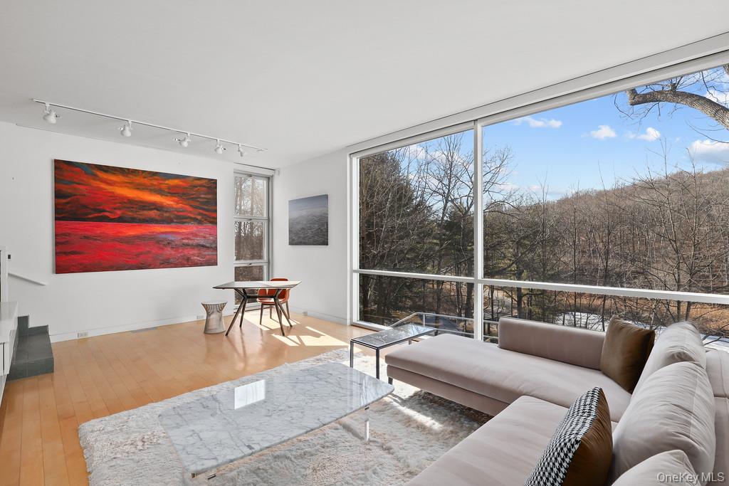 54 Cross Pond Road Pound Ridge, NY 10576 - Photo 20 of 50 a living room with furniture a rug and a large window