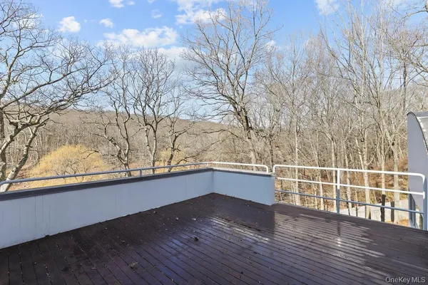 a view of a terrace with wooden floor and fence