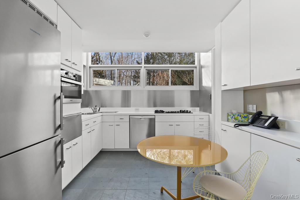 54 Cross Pond Road Pound Ridge, NY 10576 - Photo 22 of 50 a kitchen with cabinets and window