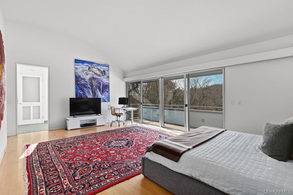 54 Cross Pond Road Pound Ridge, NY 10576 - Photo 27 of 50 a bedroom with a bed and a flat screen tv
