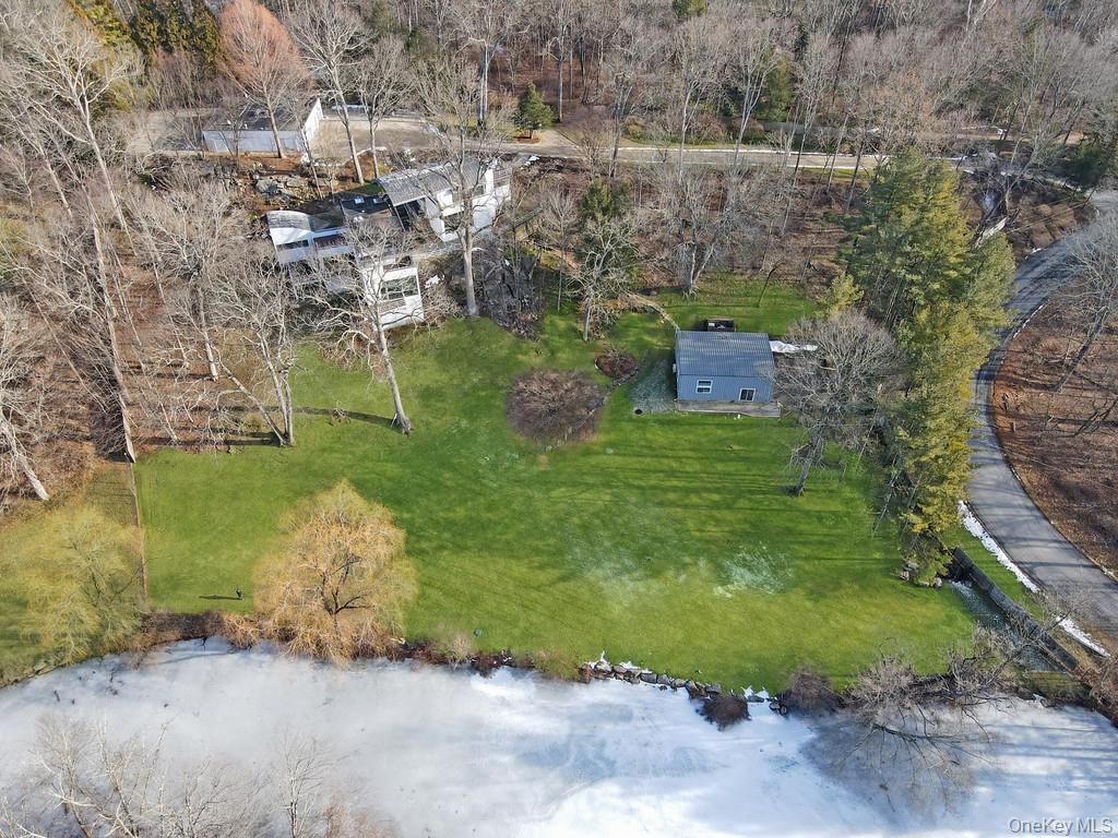 54 Cross Pond Road Pound Ridge, NY 10576 - Photo 31 of 50 a aerial view of a house with a yard