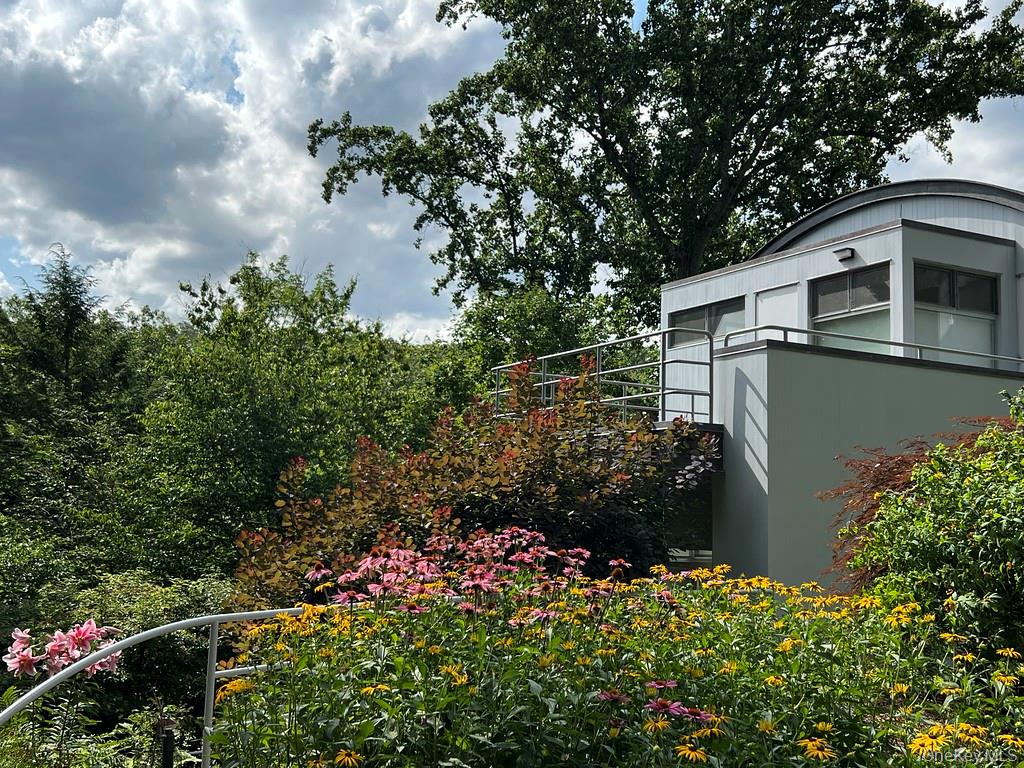 54 Cross Pond Road Pound Ridge, NY 10576 - Photo 38 of 50 a backyard of a house with lots of green space and garden view