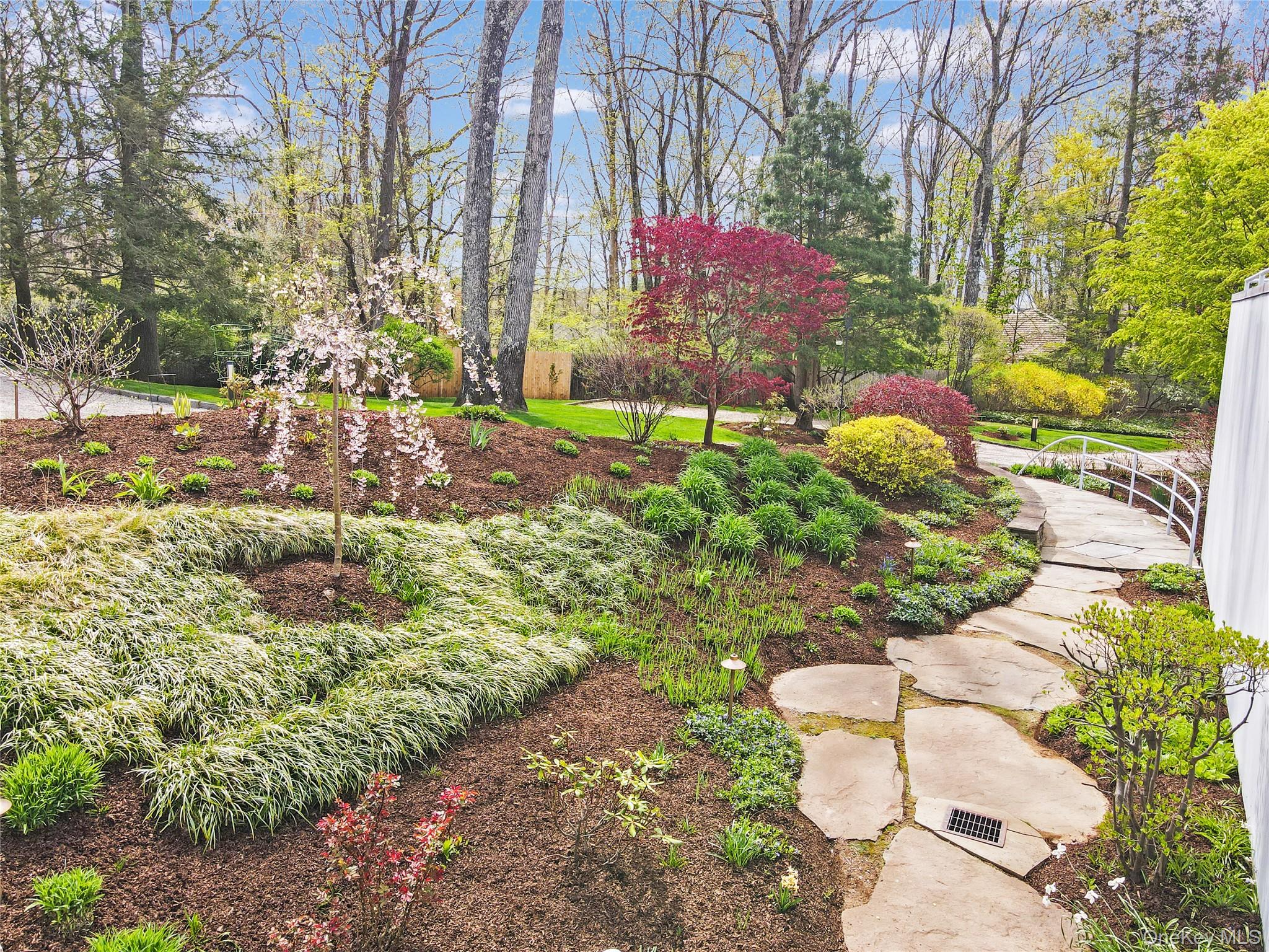 54 Cross Pond Road Pound Ridge, NY 10576 - Photo 5 of 50 a backyard of a house with a yard and outdoor seating