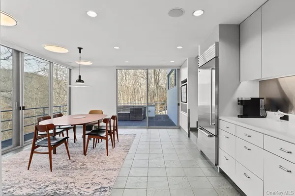 a large kitchen with sink cabinets and dining area