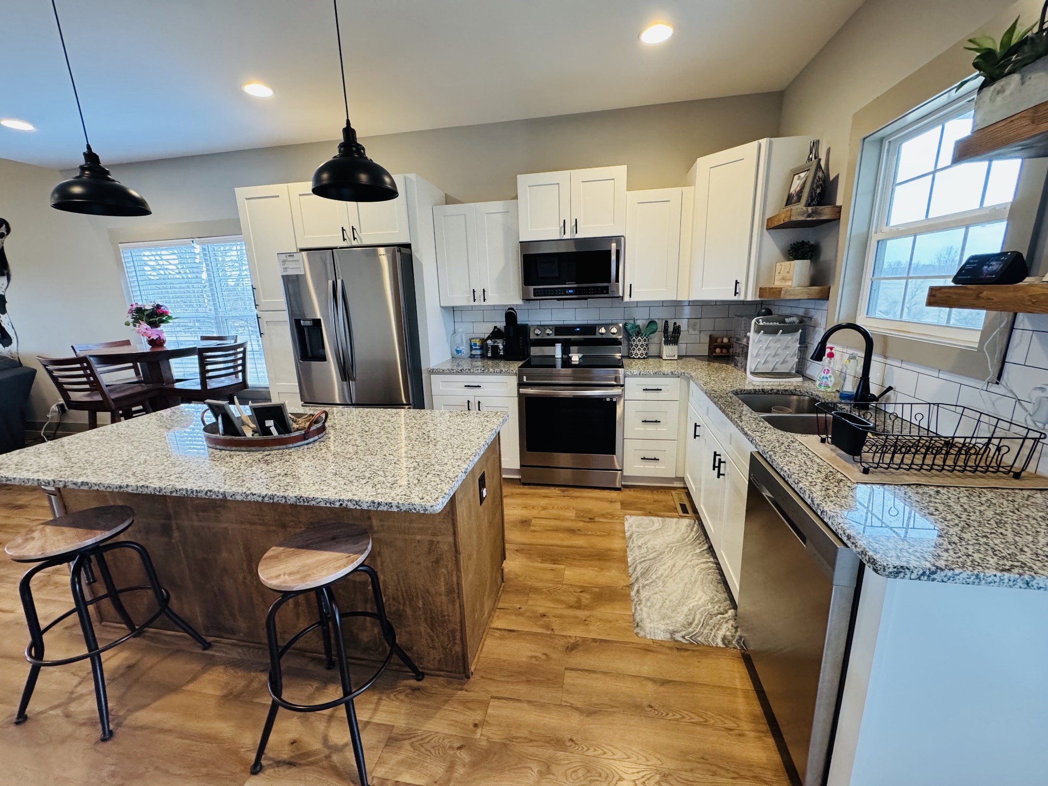 319 Lear Road Portland, TN 37148 - Photo 15 of 32 a kitchen with stainless steel appliances granite countertop a sink a stove a refrigerator cabinets and chairs