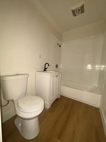 a white toilet sitting next to a bathroom sink