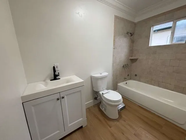 a bathroom with a toilet a sink and bathtub