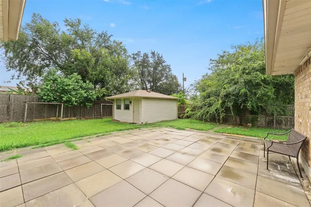 a yellow house with trees in front of it