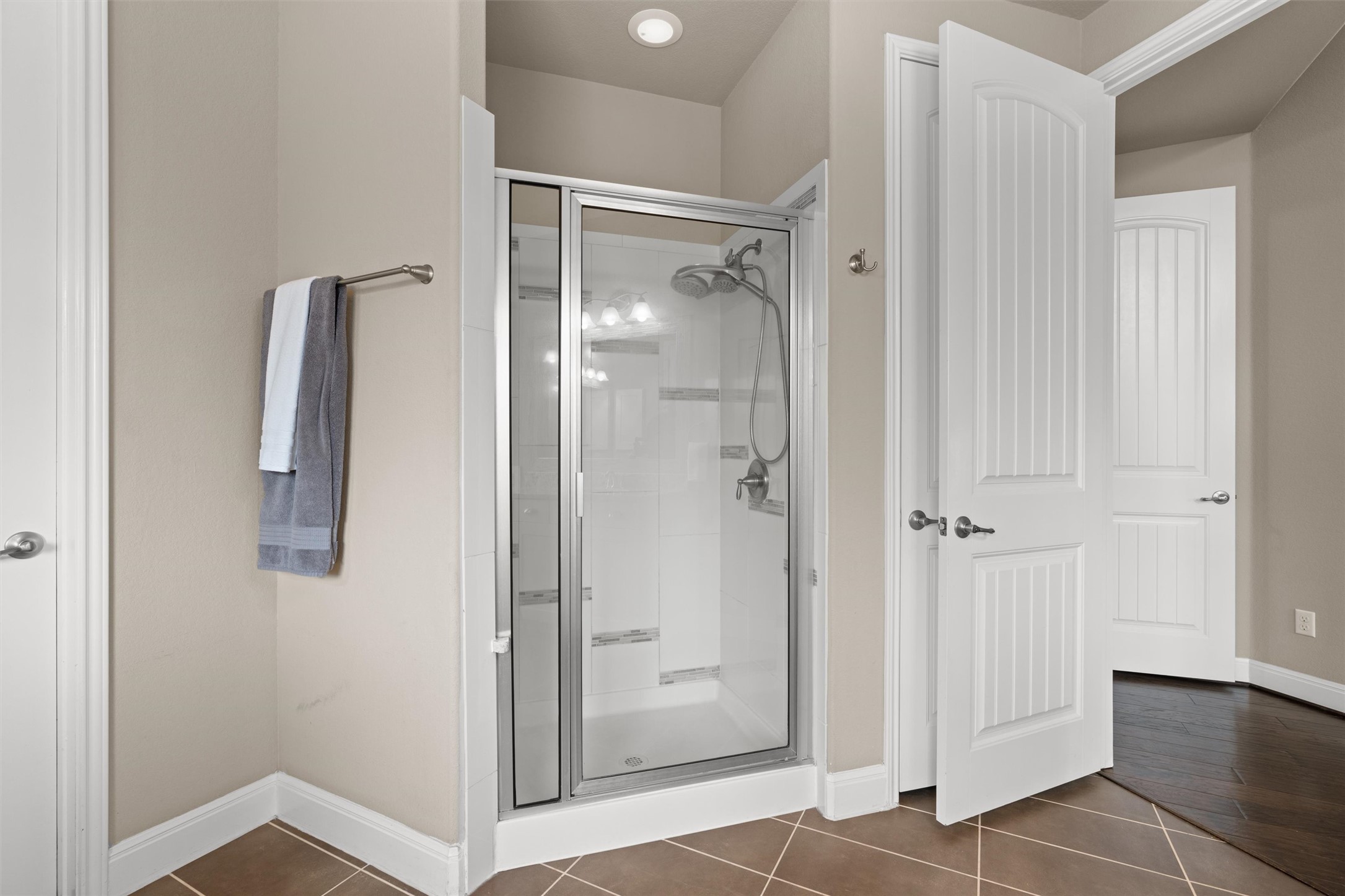 7716 Aria Loop Austin, TX 78736 - Photo 19 of 39 A glass-enclosed shower stall with a dual shower head provides a refreshing bathing experience.