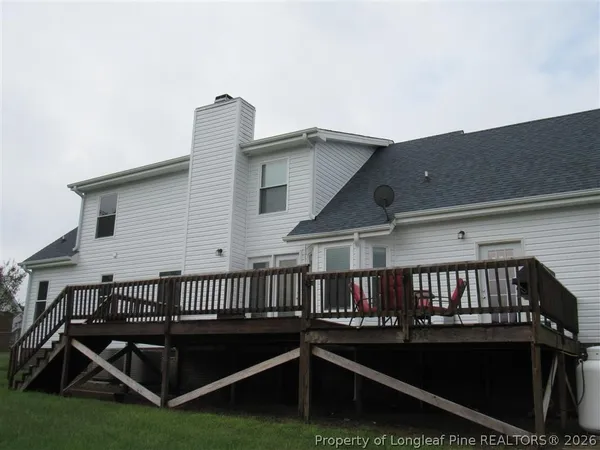 a view of roof deck with couches and a dining table