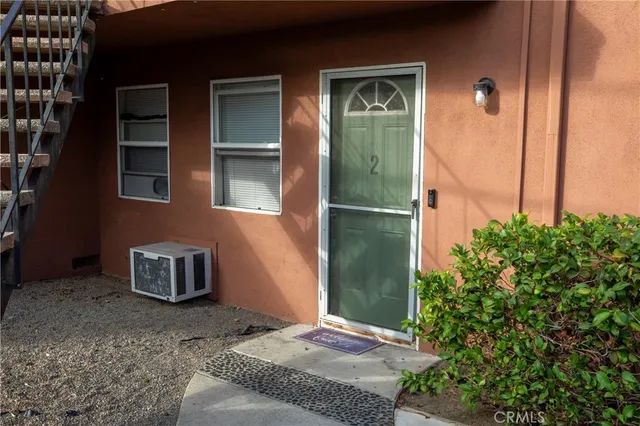 a view of a room with wooden floor and a window