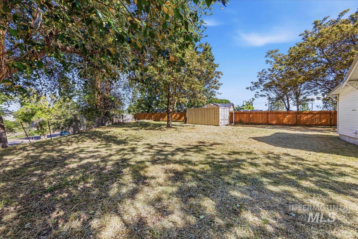 109 Parma Road Parma, ID 83660 - Photo 29 of 31 Expansive rear yard featuring mature trees and a wood privacy fence