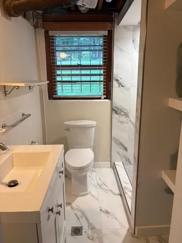 a view of an empty room and wooden floor