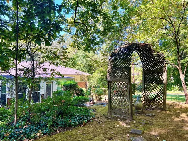 a view of a backyard with large tree