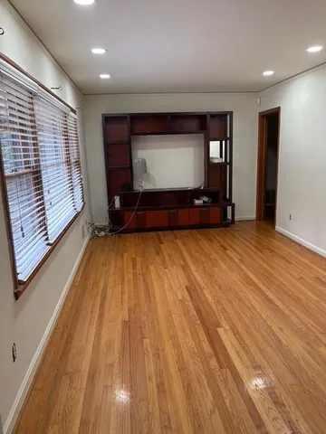 a view of room with window and wooden floor