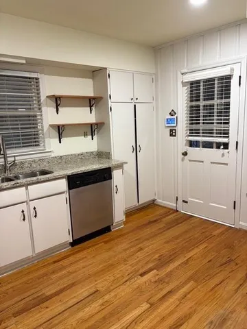 a kitchen with stainless steel appliances granite countertop a sink and wooden cabinets
