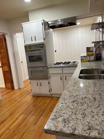 a view of a kitchen with wooden floor