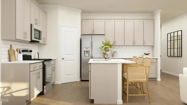 a utility room with cabinets washer and dryer