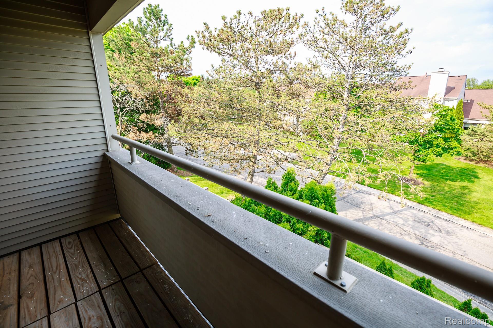 716 Eton Court Rochester, MI 48307 - Photo 12 of 41 Master suite with upper-level balcony featuring wood-finish flooring and a metal railing