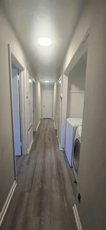 a view of a hallway with washer and dryer