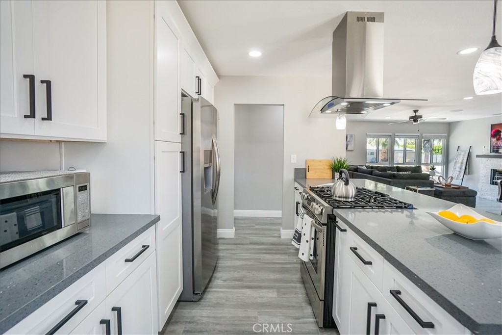 39120 Paradise Way Cathedral City, CA 92234 - Photo 12 of 41 a kitchen with stainless steel appliances granite countertop a sink and stove