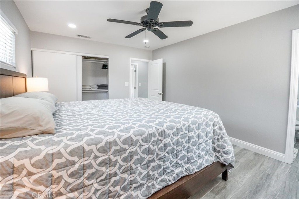 39120 Paradise Way Cathedral City, CA 92234 - Photo 17 of 41 a bedroom with a bed and a chandelier