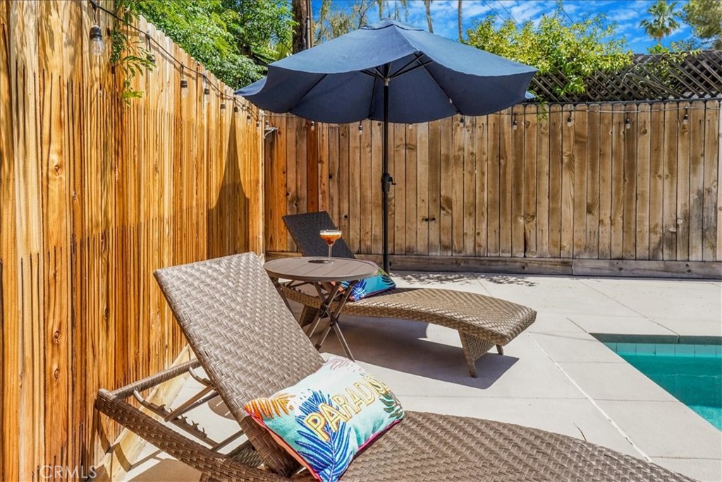 39120 Paradise Way Cathedral City, CA 92234 - Photo 32 of 41 a view of a patio with a table and chairs under an umbrella