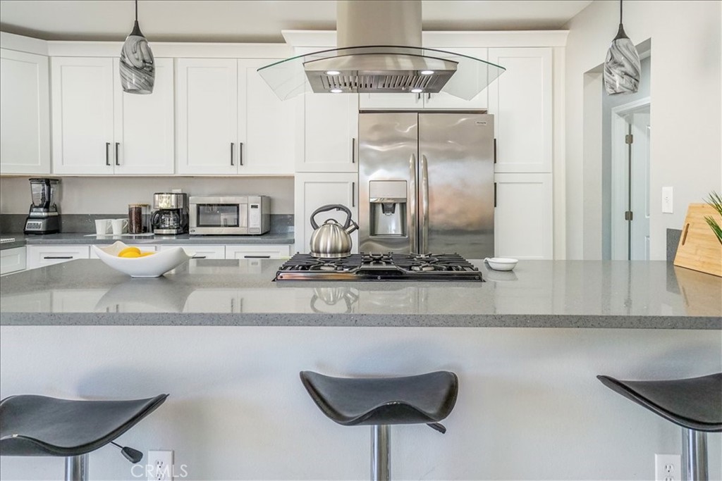 39120 Paradise Way Cathedral City, CA 92234 - Photo 10 of 41 a kitchen with a refrigerator a stove and a cabinets