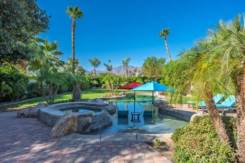 a view of a table and chairs under an umbrella