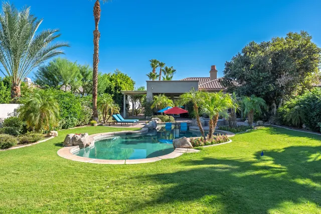 a view of a swimming pool with a yard