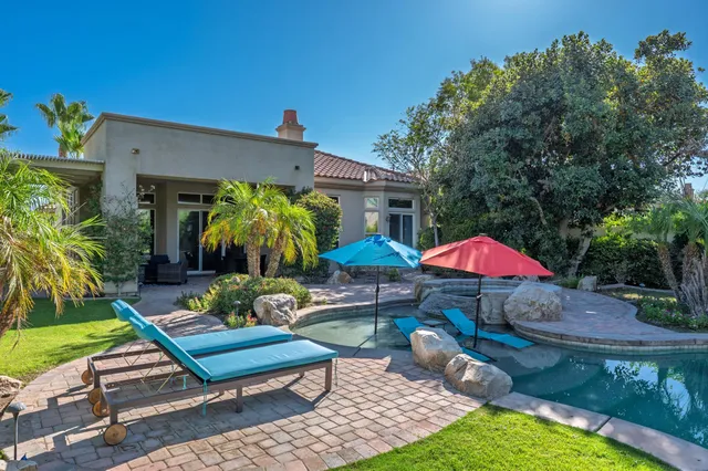 a view of a backyard with a patio and garden