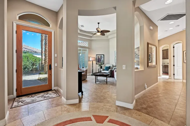 a view of a hallway with living room and dining room view