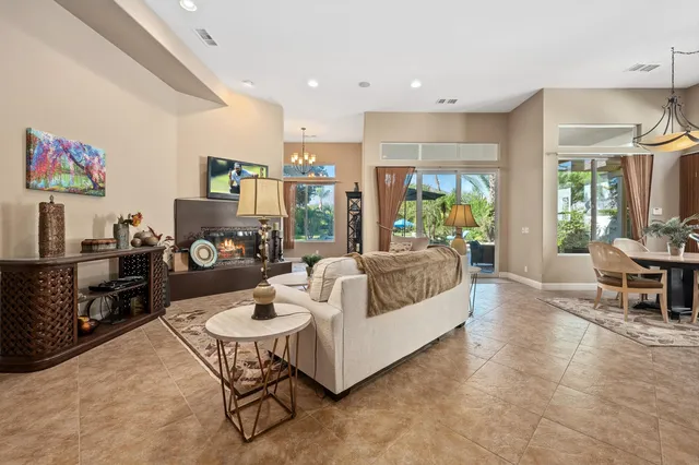 a living room with furniture and a dining table with kitchen view