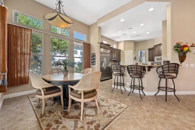 a view of a dining room with furniture window and outside view