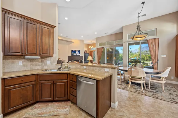 a kitchen with a sink and wooden cabinets