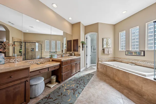 a large bathroom with a large tub and sink