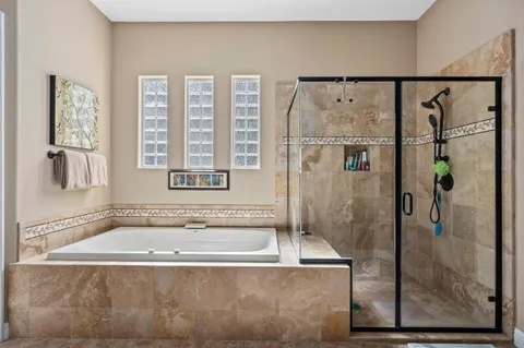 a bathroom with a shower and a bath tub