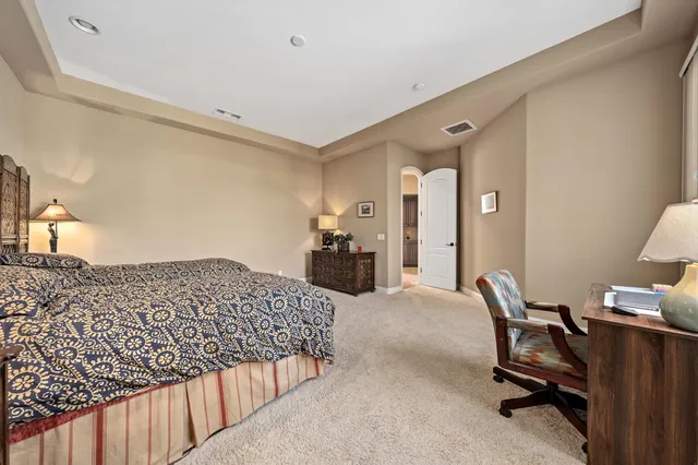 a bedroom with a bed and a desk