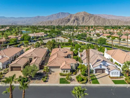 an aerial view of residential house and sandy dunes