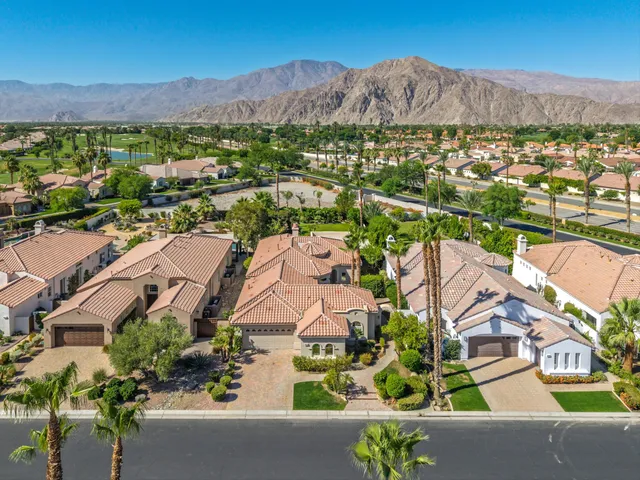 an aerial view of residential house and sandy dunes