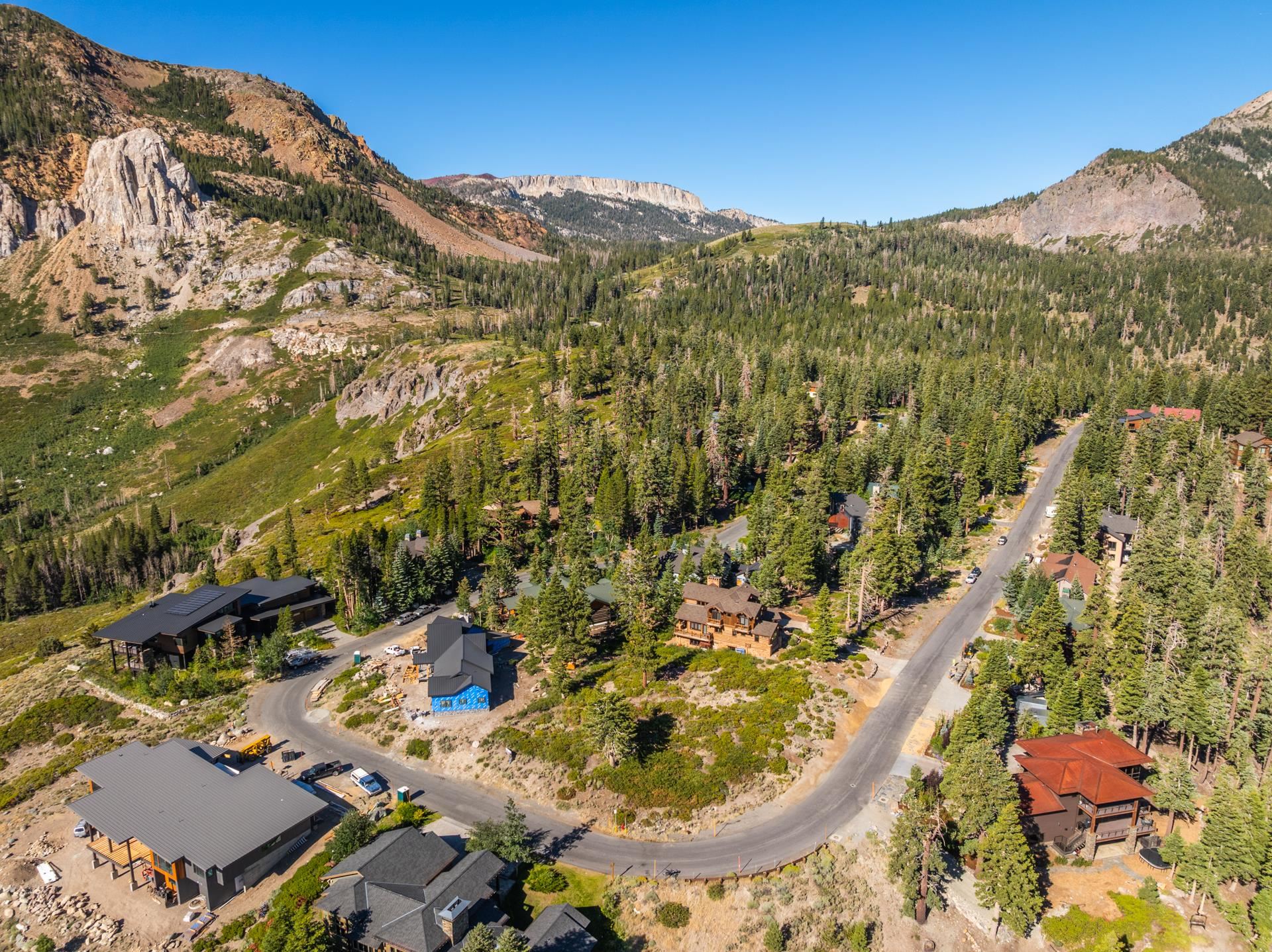 480 Fir Street Mammoth Lakes, CA 93546 - Photo 4 of 36 Aerial view of property and surrounding area featuring a mountain backdrop and a heavily wooded area