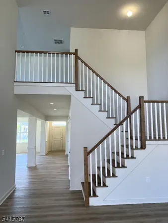 a view of staircase with white walls and a window
