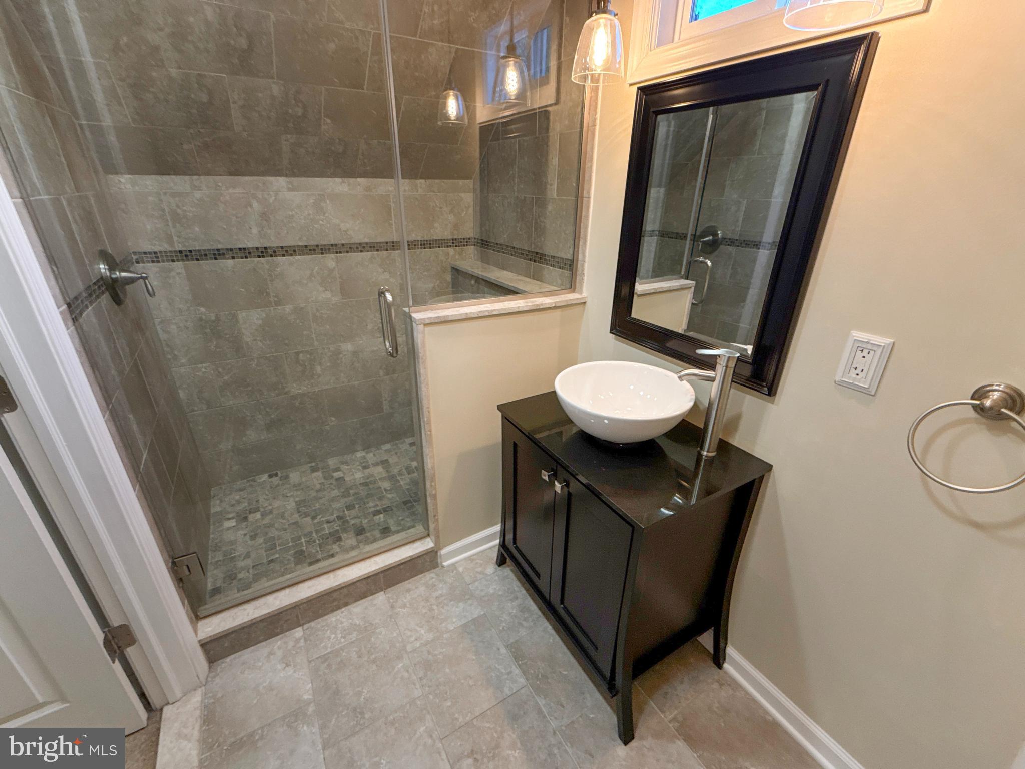 133 North Line Road Newtown Square, PA 19073 - Photo 13 of 23 a bathroom with a granite countertop sink a toilet a mirror and vanity