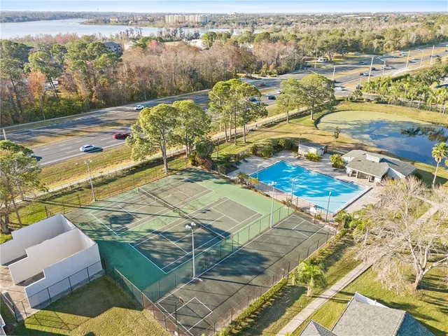 a view of a swimming pool with a yard and plants